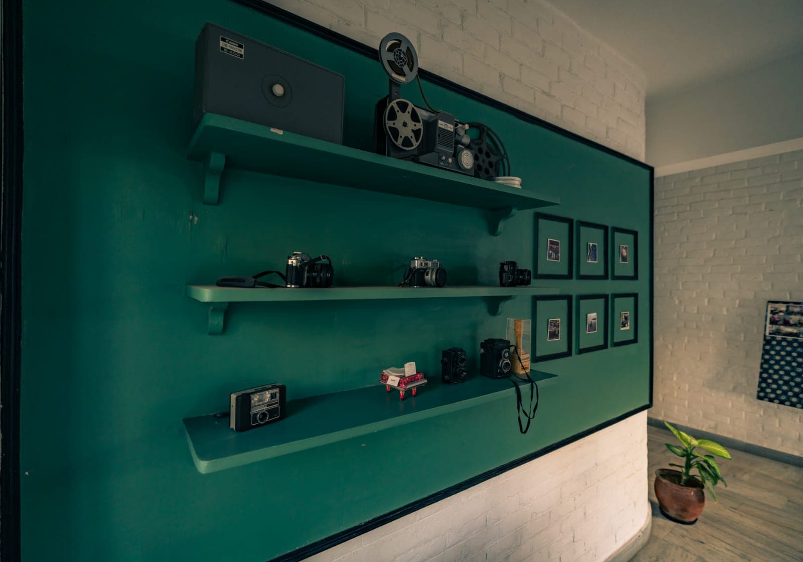 Monochrome media wall inside TOSS representing the creative ecosystem.